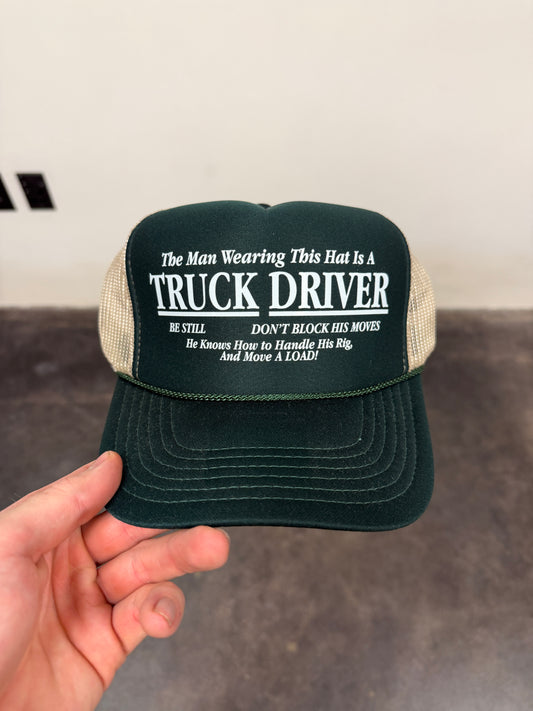THE MAN WEARING THE HAT IS A TRUCK DRIVER